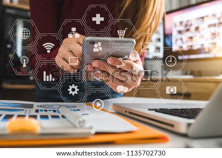 businesswoman or Designer using smart phone with laptop and digital tablet computer and document on desk in modern office with virtual interface graphic icons network diagram
