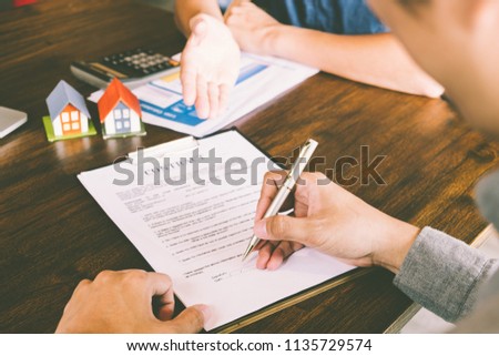 House Contract, Man signs a contract to purchase a home with a real estate agent, Loan and Payment Calculators ,Financial Calculators