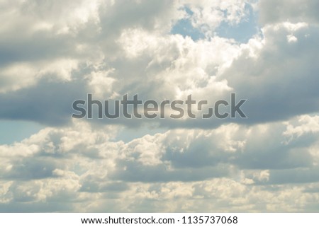 Beautiful dark clouds on a blue sky, background for design, sunny day