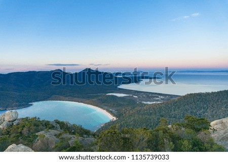 Aerial view on picturesque bay with beach and mountains covered with forest. Wineglass bay in Freicynet national park, Tasmania, Australia