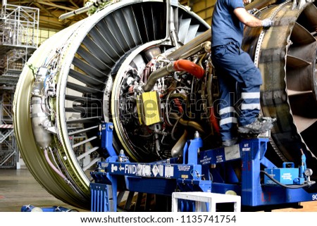Jet engine remove from aircraft (airplane) for maintenance at aircraft hangar.Jet engine maintenance and change part by aircraft technician . Royalty-Free Stock Photo #1135741754