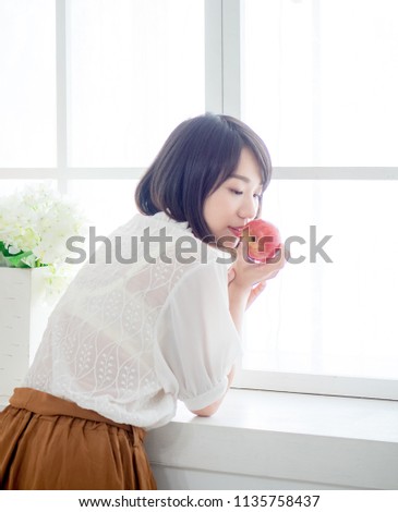 Woman having breakfast on window