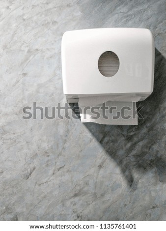 Isolated tissue box on clean wall in woman toilet and men restroom.