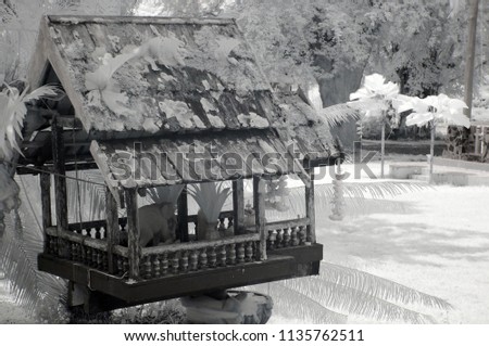 Old wooden joss house in the garden from near infrared style by IR mode.