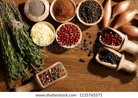 Spice. Red and black pepper, herbs and vegetables on a dark wooden background. Top view.