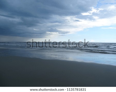 Perspective photography of storm clouds over ocean, horizon, beach.