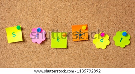 School concept. Colorful sticky notes, with letters writing school, in various shapes with pushpins and blank space, isolated on cork background.