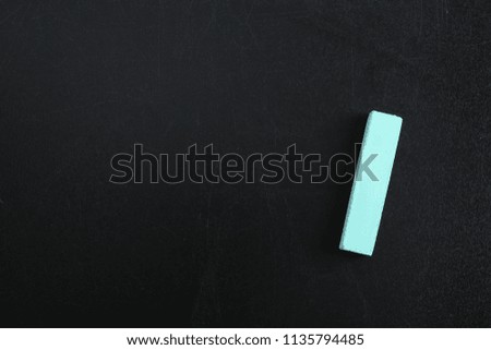 Color piece of chalk on blackboard, top view