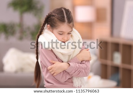 Sad little girl suffering from cold on blurred background Royalty-Free Stock Photo #1135796063
