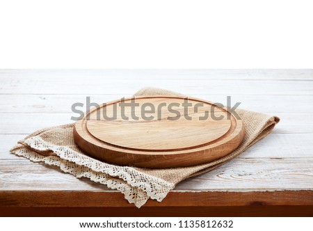 Napkin and board for pizza on wooden desk closeup. Canvas, dish towels on white wooden table background top view mock up. Selective focus.