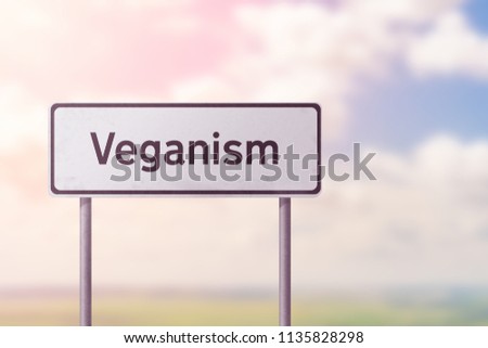 VEGANISM - white road sign.