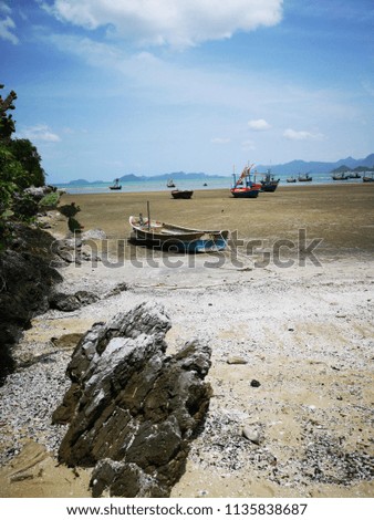 Fishing boat​ on​ beach​ and​ sea​ with​ blue sky​ background​ at​ Prachuap​ khiri​ khan, Thailand
