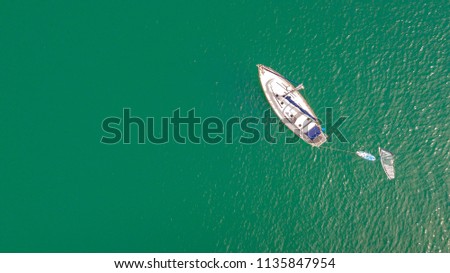 Top view yacht in the beautiful green sea.
