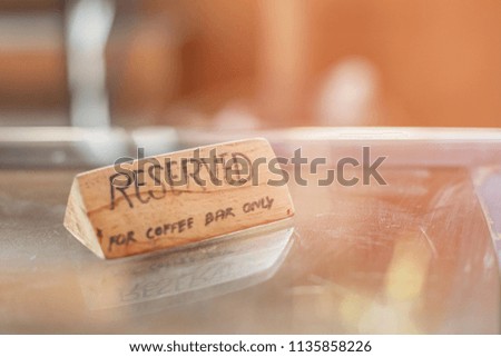 Wood label reserved concept on the table in the Bar, service for luxury customer reservation