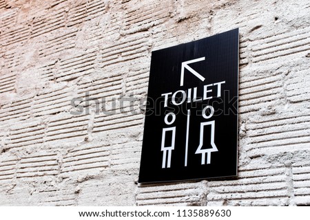 Toilet icons set. Men and women WC signs for restroom.Restroom sign on a toilet wall,on modern background.Toilet sign - Restroom Concept - black tone.