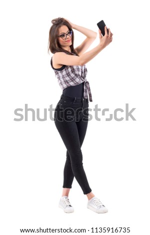 Charming stylish beauty woman holding mobile phone and taking selfie photo. Full body length isolated on white background.