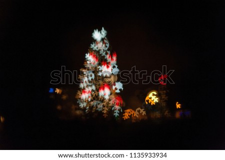 Christmas abstract blur background. Abstract christmas tree made of snowflakes bokeh. Christmas tree with defocused lights. 