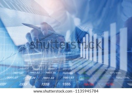 Financial investment, business analysis concept. Double exposure of businessman and stock market or forex graph. Economy trends background. Finance background for business design or presentation. Royalty-Free Stock Photo #1135945784