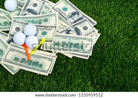 White golf ball and tee on banknote for bet on grass green background with copy space, gambling with sport concept