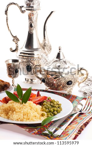 Couscous with green-stuffs and Arabic tableware, east kitchen Royalty-Free Stock Photo #113595979