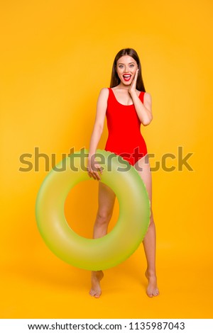Vertical photo portrait of fit slim with matte colorful lipstick fit slim shouting beautiful lady standing on tiptoes holding big transparent lifebuyo in hand isolated bright vivid background