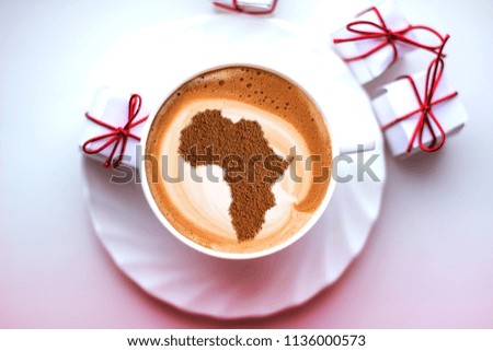 cup of coffee cappuccino with a picture of Africa on milk foam
