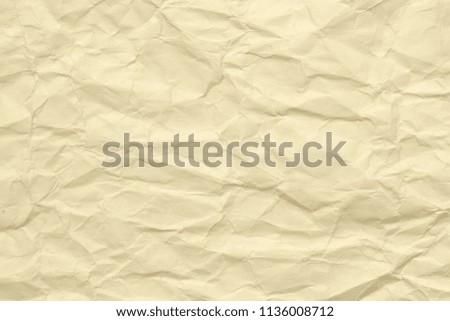 Paper beige color aged and wrinkled. Background of brown color with kinks and fraying.