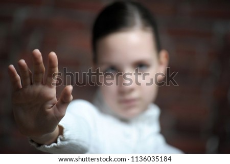 Teenage girl making stop gesture