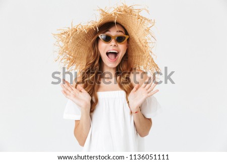 Portrait closeup of adorable woman 20s wearing big straw hat and sunglasses posing on camera with happy smile isolated over white background