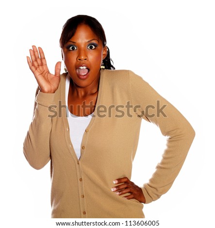 Surprised charming girl with hand up against white background