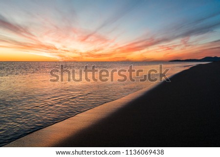 Breathtaking view on sunset over the sea, looking from the beach. Explosion of colors.  