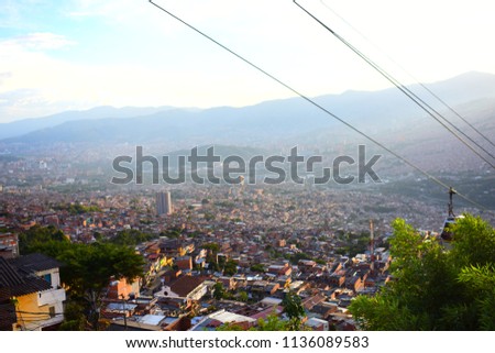 Top picture View of Medellín Antioquia Colombia from Bicentenario the city in the sun afternoon. cable car going down.