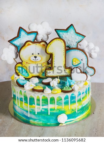 Modern bright children's cake with gingerbread cookies for one year.
