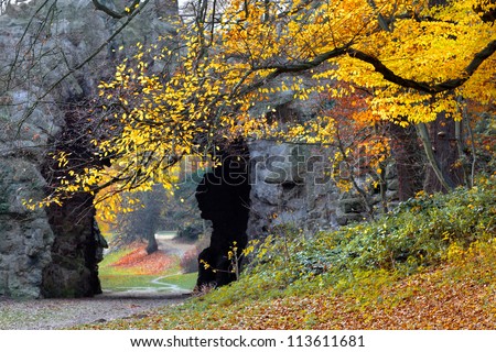 Beautiful grotto in the autumn park. Autumn landscape.