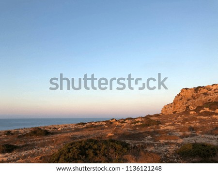The summer sunrise of coast of the Mediterranean Sea on the abrupt rock of the island of Cyprus  