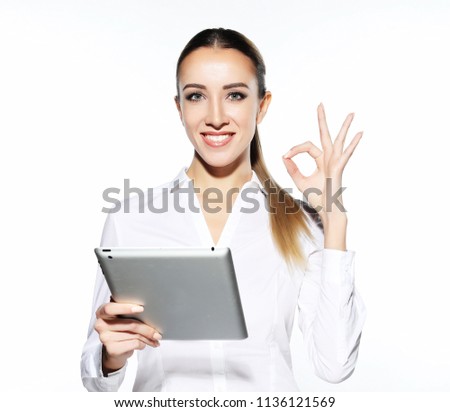 Attractive businnes woman  using tablet showing thumbs up.