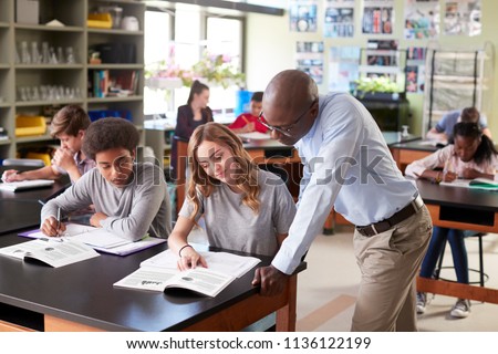 Male High School Tutor Teaching Students In Biology Class Royalty-Free Stock Photo #1136122199