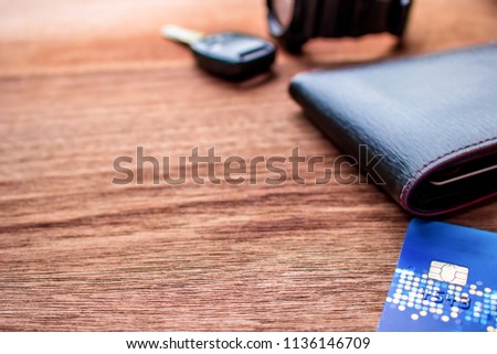 Close up Credit Cards wallet smart phone car key Watch on the wood background Holiday concept Travel Accessories and space for texture