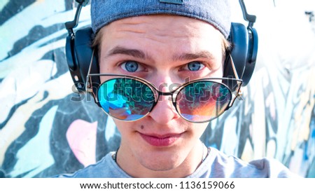 Young man sunglasses headphones portrait