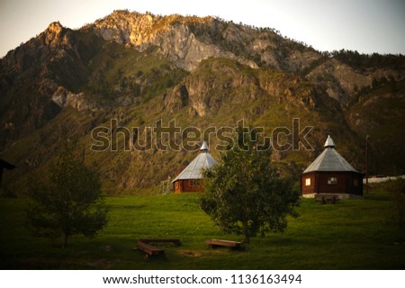 River valley Che-chkish. Pentagonal house-Ails in the meadow. Chemal tract. Altai mountains. Siberia. Russia.                              