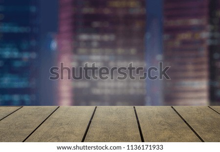 Open space for product on wood with city background.  New item product display with copy space for words.