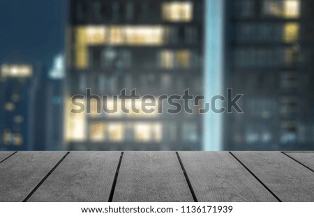 Open space for product on wood with city background.  New item product display with copy space for words.