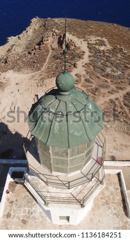 Aerial photo of old abandroned lighthouse with views to deep blue sea