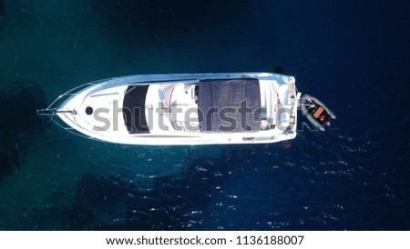 Aerial photo of luxury speed boat docked in iconic island of Mykonos, clear waters of Super Paradise beach, Cyclades, Greece