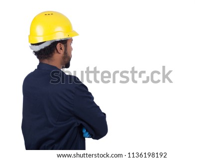 rear shot of a repairman wearing his uniform and helmet, standing crossed arms and looking away, isolated on white background
