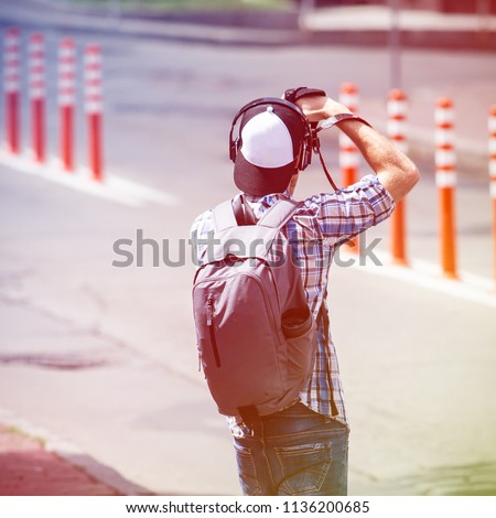 young man taking pictures on the streets of the city