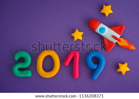 2019 New Year. Space rocket and Numbers are made out of play clay (plasticine).