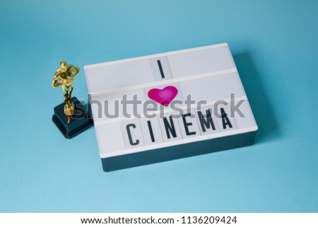 Lightbox with love message to the cinema on colorful background