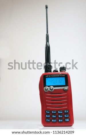 red walkie talkie radio on the white background