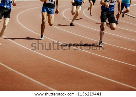 legs group runners sprinter men race 200 meters in stadium Royalty-Free Stock Photo #1136219441